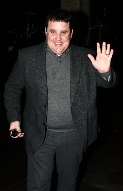 Comedian Peter Kay smiling and waving.