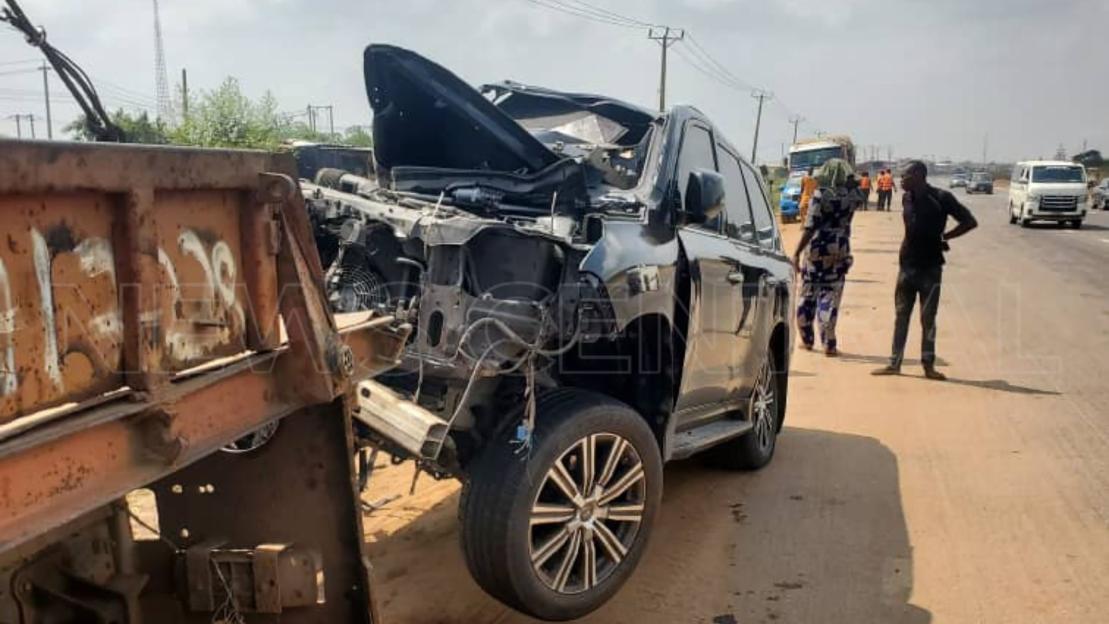 A heavily damaged black Lexus SUV, possibly involved in an accident, is being towed from the scene.