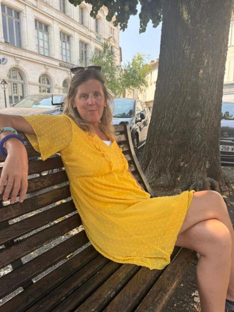 Shona Sibary, age 55, sits on a park bench.