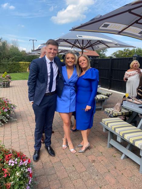 Henry with his older sister Olivia and mum Lucy posing for a photo.