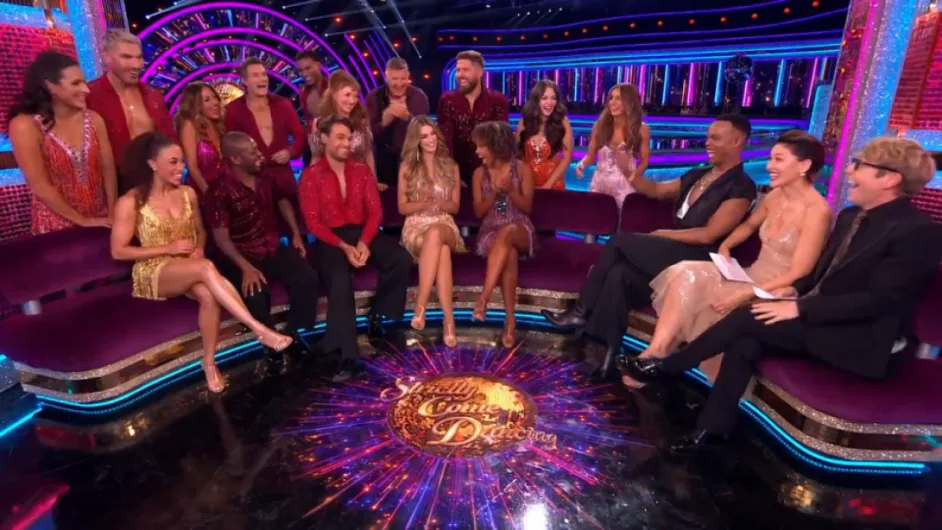 An Emmerdale star tells a joke to new Strictly Come Dancing presenters as cast members look on.