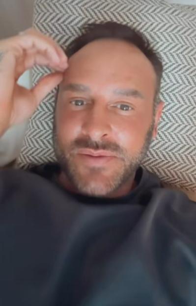 Lee Andrews resting his head on a patterned pillow.