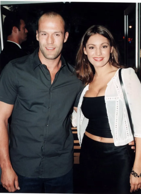Jason Statham and Kelly Brook smiling at the camera.