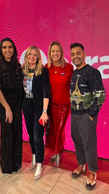 Christine Lampard and three other presenters standing in front of a pink background.