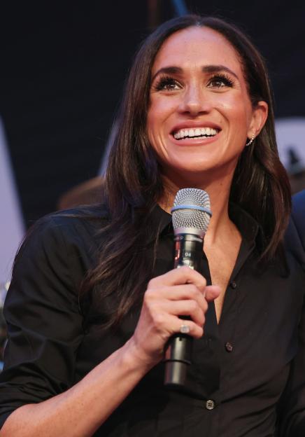 Prince Harry and Meghan Markle speaking at an event.