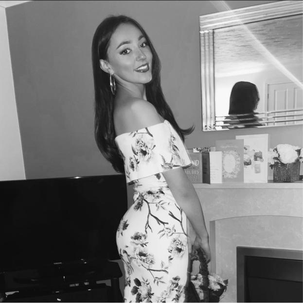 Jess Waterman smiling in a floral off-the-shoulder dress.