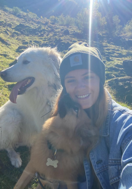Hana Carter with her two dogs outdoors.