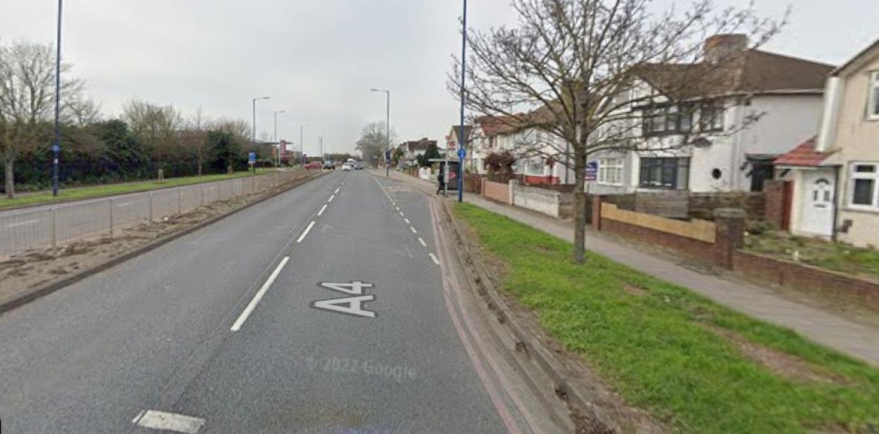 View of an A4 road with houses and a bus stop to the right.
