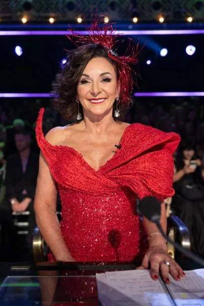 Shirley Ballas wearing a red sequined dress and a red hairpiece as a guest judge on Dancing with the Stars.