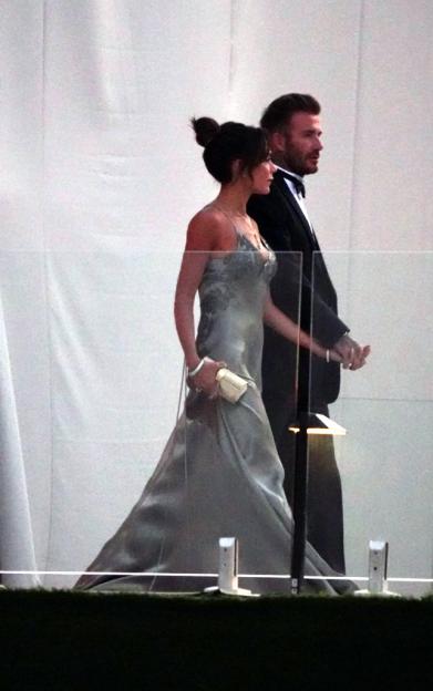 David and Victoria Beckham walking hand-in-hand.