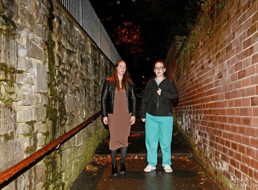 Leanna Baggaly and Jade Chantelle, two women associated with Mums Against Youth Attacks, standing on an outdoor stairway at night.