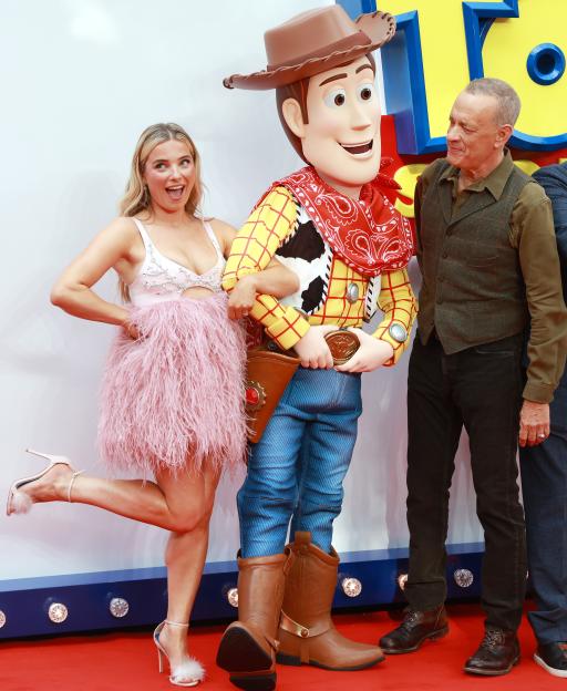 Sian Welby, a Woody mascot, and Tom Hanks at the "Toy Story 5" UK launch event.