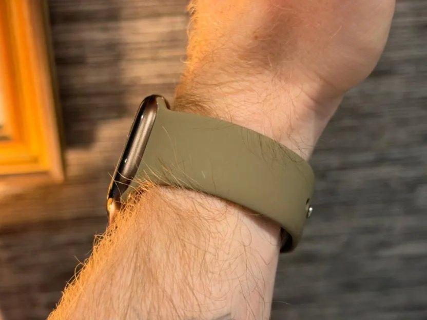 Side profile of an Apple Watch on a hairy wrist.