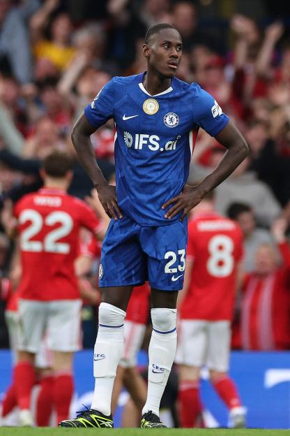 Chelsea's Trevoh Chalobah stands with hands on his hips after his team concedes a third goal.