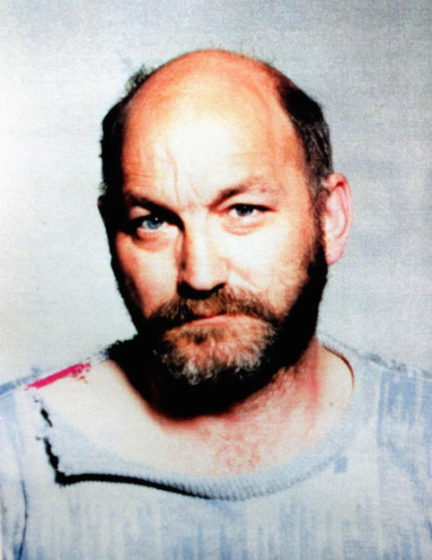 Headshot of Robert Pickton, a man with a bald head, dark beard, and blue eyes, wearing a light blue shirt.