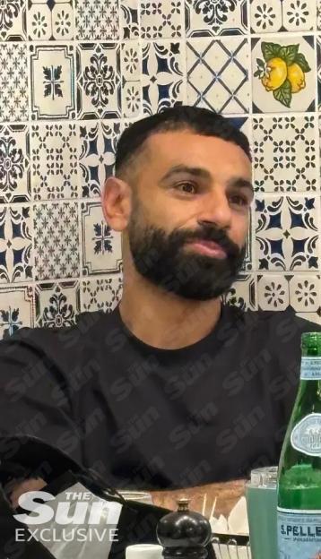 Mohamed Salah wearing a black t-shirt.