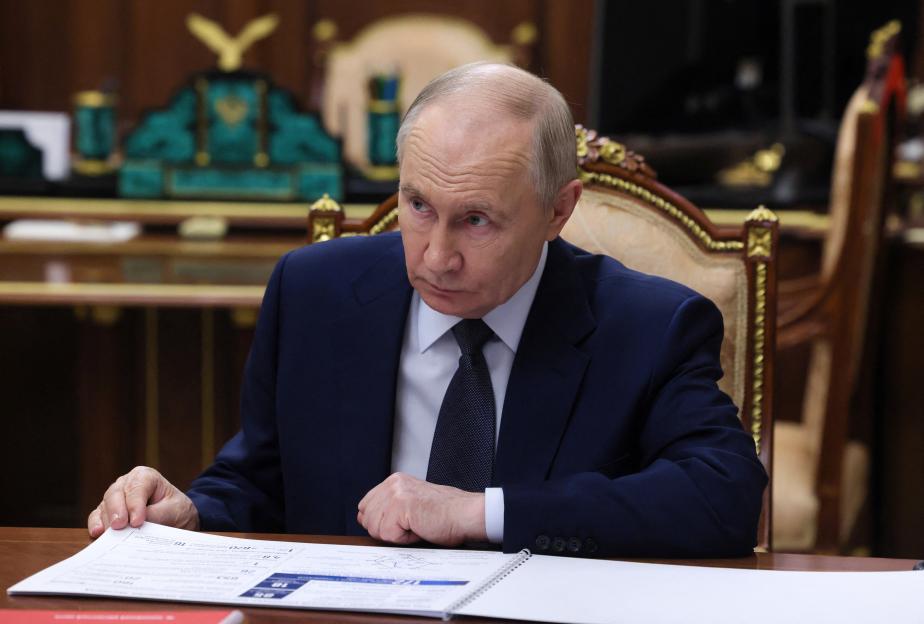 Russian President Vladimir Putin attends a meeting with Russian Export Centre Director General Veronika Nikishina in Moscow