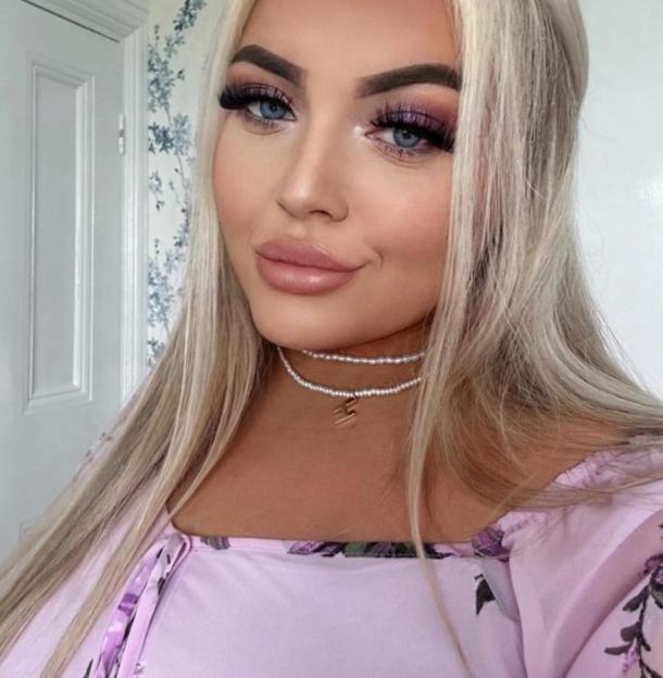 Hannah Bloor posing in a sequined dress and necklaces.