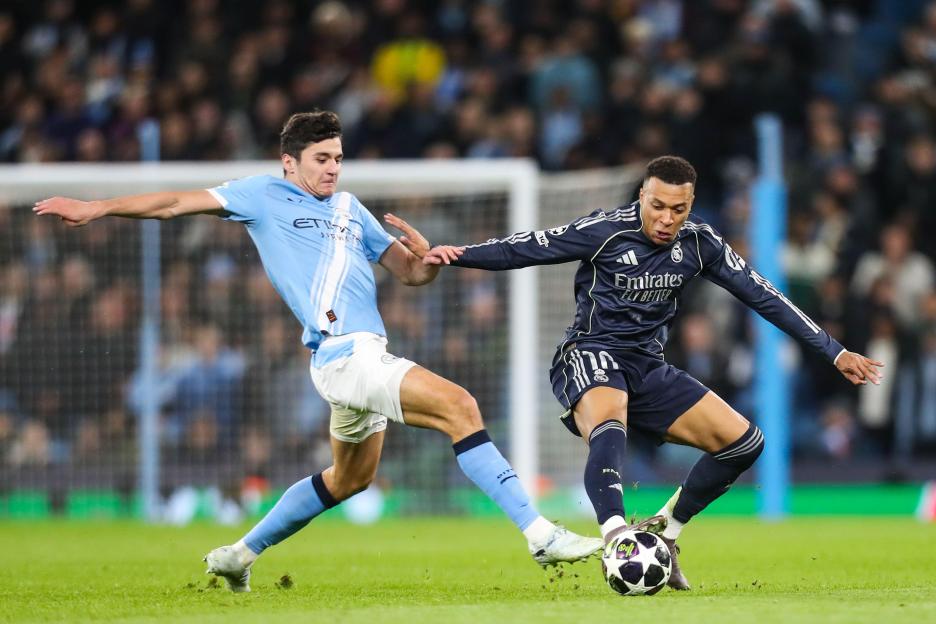 Manchester, UK. 17th Mar, 2026. Kylian Mbappe Of Real Madrid battles with Abdukodir Khusanov Of Manchester City during the Manchester City v Real Madrid UEFA Champions League, Round of 16, 2nd Leg match at the Etihad Stadium, Manchester, England on 1