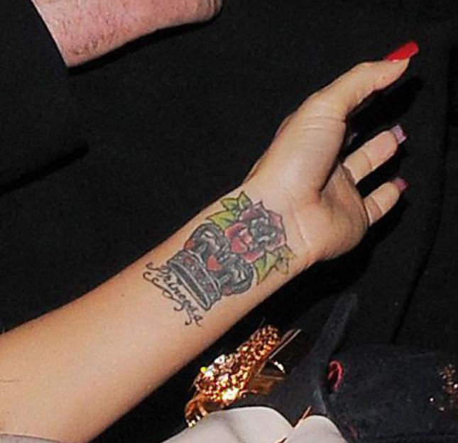 A close-up of Katie Price's wrist tattoo of a trophy with a rose and the word "Princess" on it.