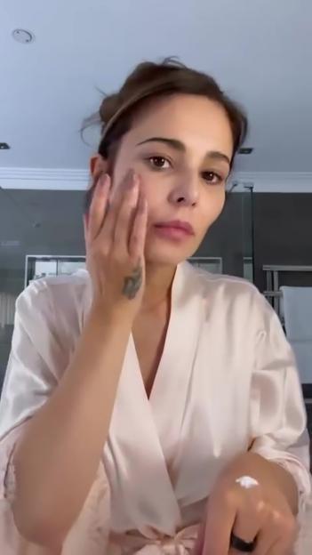Cheryl Cole applying face cream.