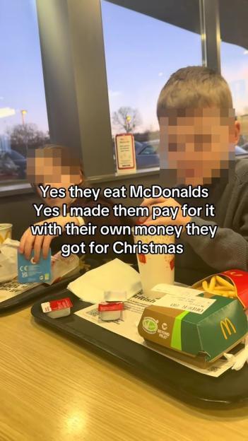 A parent teaching their kids about financial responsibility by having them pay for McDonald's with their own Christmas money.