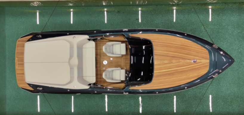 Overhead shot of a luxury boat with a wooden deck and white seats.