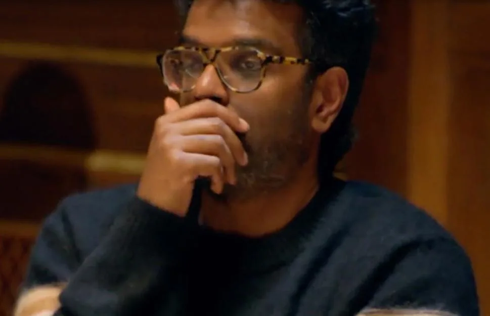 Romesh Ranganathan looking concerned with his hand over his mouth.