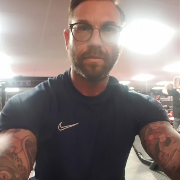 Westley O'Bryan in a gym, wearing a navy blue Nike shirt and glasses.