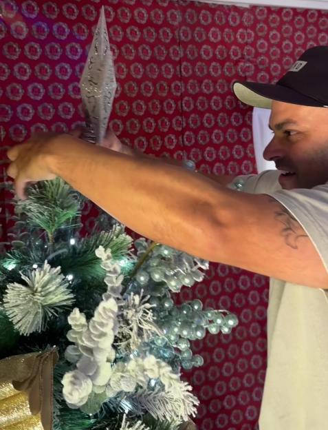 Olivia Attwood decorates a Christmas tree.