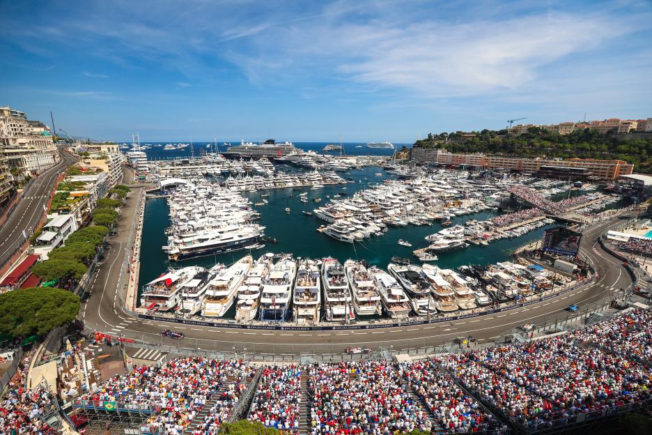 Aerial view of the F1 Grand Prix of Monaco race and Monaco harbor filled with yachts and spectators.