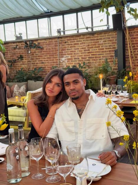 A young woman and man sitting at a restaurant table.