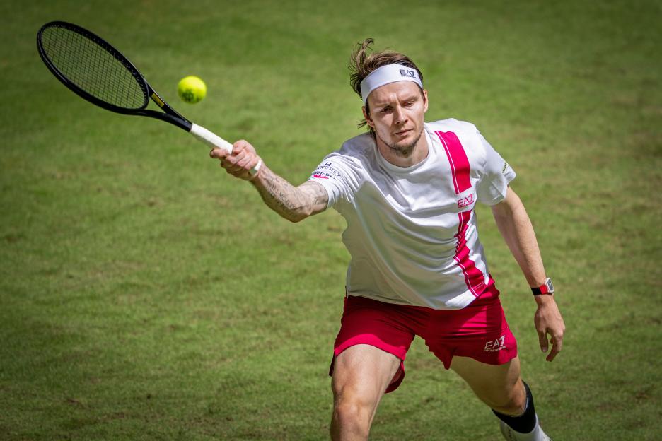 Alexander Bublik of Kazakhstan playing a forehand shot during a tennis match.
