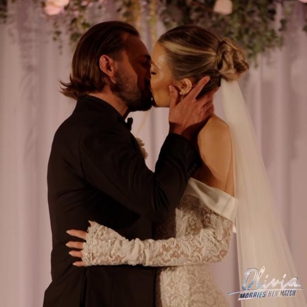 Olivia Attwood and Bradley Dack kissing at their wedding.
