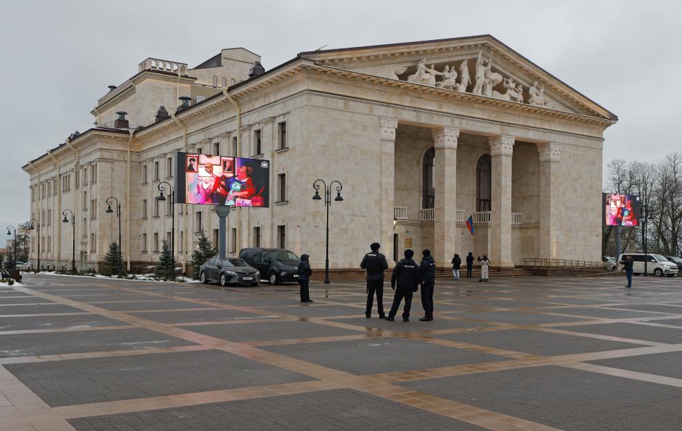 Police officers stand guard outside the restored Mariupol theatre.
