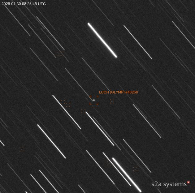 A satellite photograph showing the LUCH (OLYMP) satellite and additional objects, tumbling in its graveyard orbit.