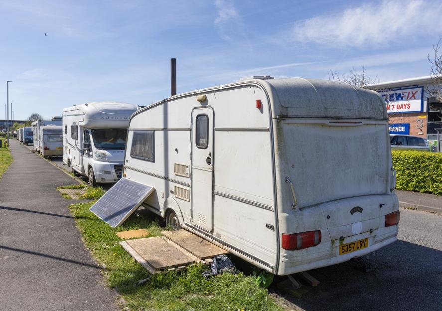 Caravans and vans parked along Morland Road in Glastonbury.