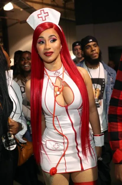 Cardi B backstage wearing a nurse costume.