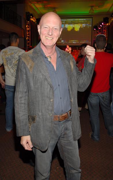 Drummer Chris Slade of AC/DC smiling at a Harmonix and MTV Games Rock Band Party.