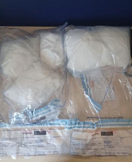 Large packages of white powder in clear plastic evidence bags.