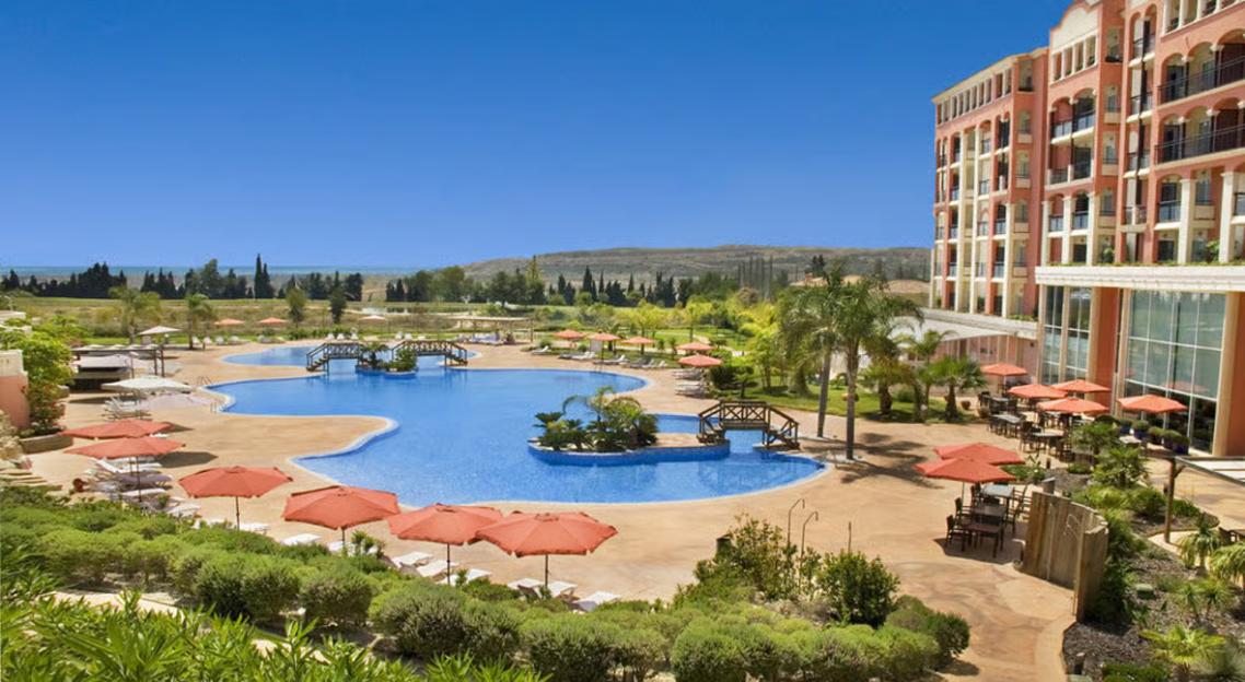 Sercotel Hotel Bonalba Alicante exterior with a large swimming pool, patio dining, and lush landscaping.