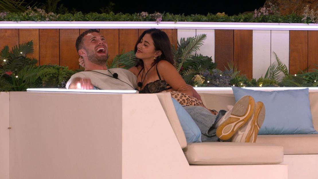 Curtis Pritchard laughing while sitting with Kyra Lizama on 'Love Island All Stars'.