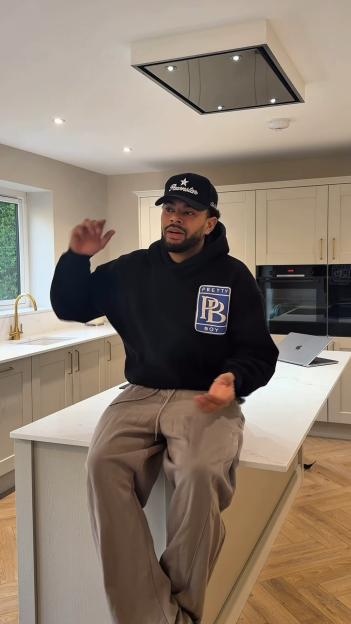 Wes Nelson sitting on a kitchen island.