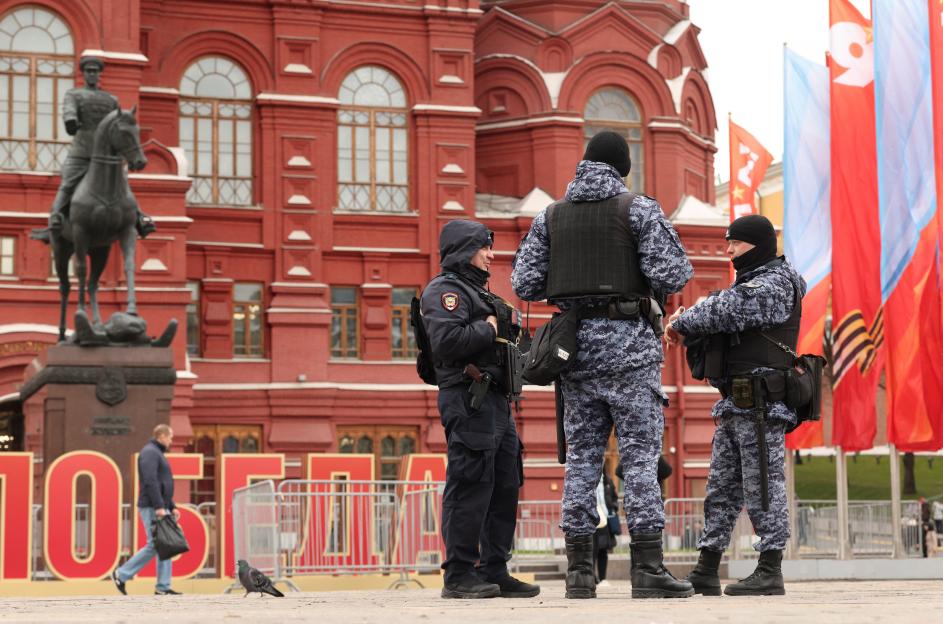 Russian officers speak near Victory Day decorations in central Moscow