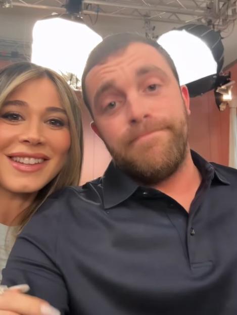 Woman with blonde hair smiling next to a man with a beard making a funny face.