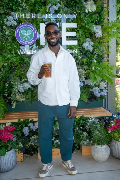 Tinie Tempah holding a drink at Wimbledon.