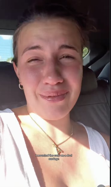 A young woman with teary eyes looking into the camera.