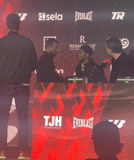 Shakur Stevenson races across the stage to confront Teofimo Lopez at a press conference.