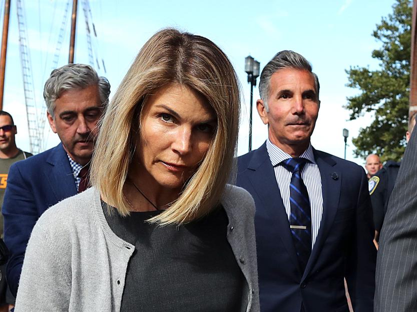 Actress Lori Loughlin and her husband, fashion designer Mossimo Giannulli, leave a Boston courthouse.