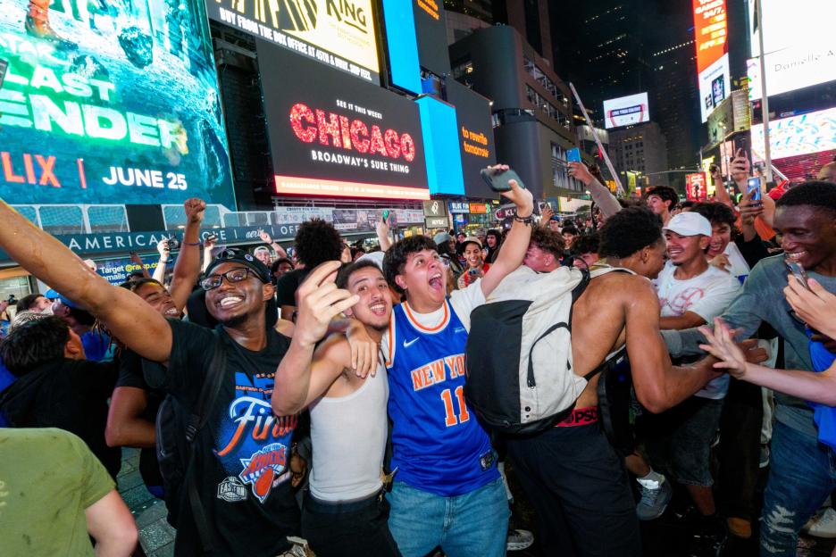 Knicks fans cheer excitedly while watching Game 4 of the NBA Finals in Times Square.